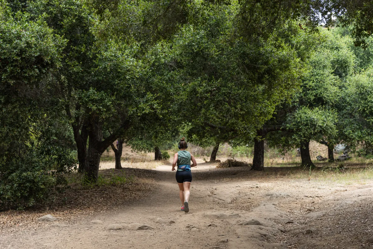 Trail runner running through Stevens Park Trail