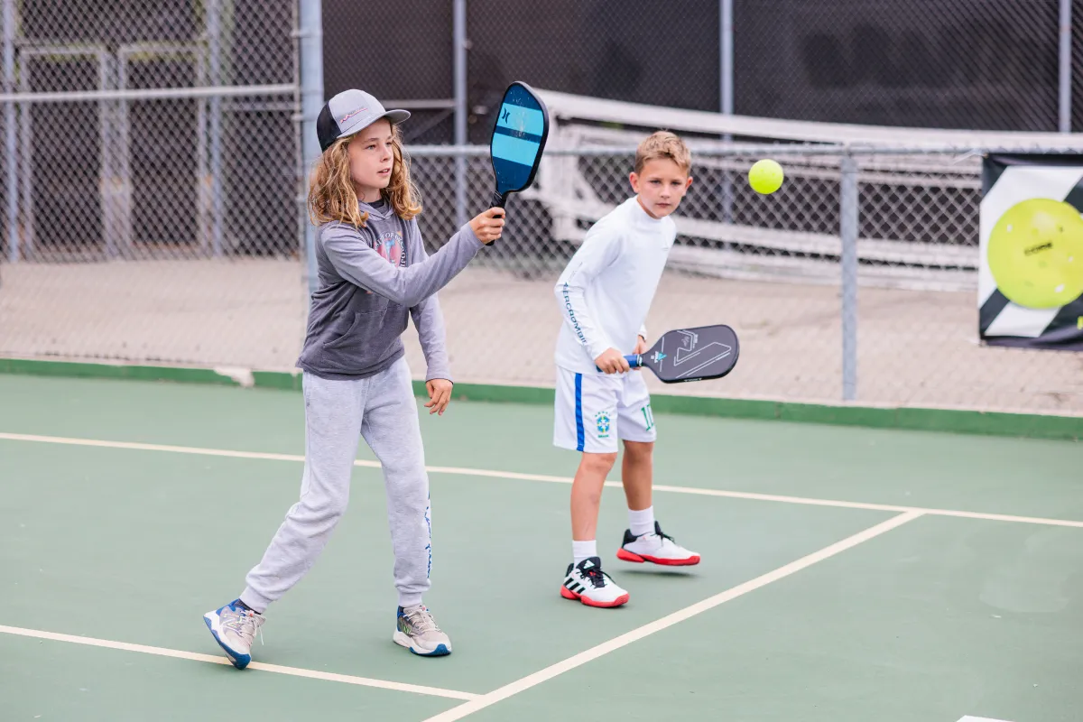 Two campers at Pickleball Camp volleying