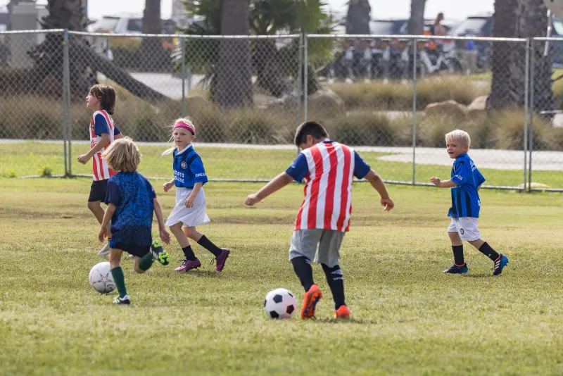 Campers pass the soccer balls while running around