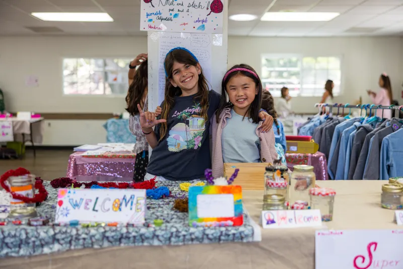 Campers pose in front of their pop up shop at Bizzy Girls Entrepreneur Camp