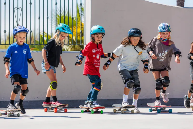 Campers start skate boarding in a line at Skate Camp