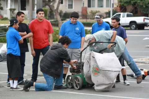 Job Apprentice Program participants repair equipment with City staff